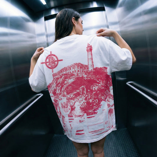 Person wearing a white t-shirt with red graphics in an elevator